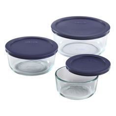 four glass containers with lids and lids on each one, set against a white background