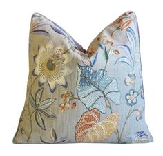 a blue pillow with colorful flowers on it