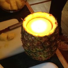 a pineapple sitting on top of a cutting board