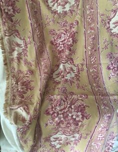 an old blanket with pink flowers on it