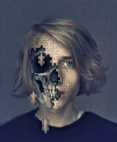 a young boy with puzzle pieces on his face and the image of a skull in front of him