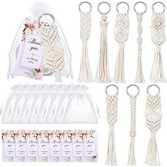 a bunch of white tassels and keychains with some tags on them