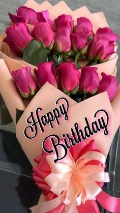 a bouquet of pink roses with a happy birthday sign