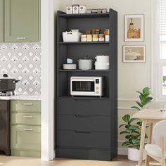 a kitchen with green cabinets and a microwave on top of the cabinet in front of it