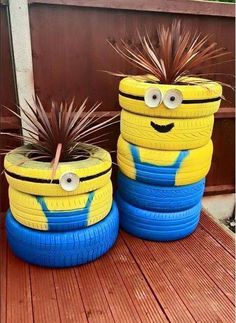 two yellow and blue tires sitting on top of a wooden deck next to each other