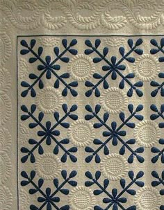 a blue and white quilted wall hanging