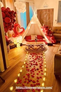 a living room decorated with balloons and lights for valentine's day or other special occasion