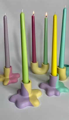 five candles with different colors and shapes on them