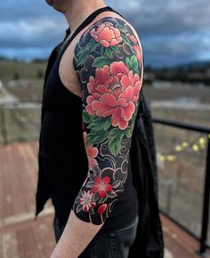 a man with a flower tattoo on his arm