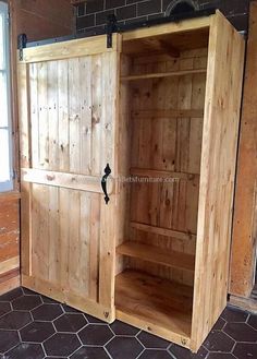 an open wooden cabinet sitting inside of a room