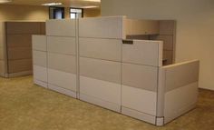 an office cubicle with multiple dividers and cabinets