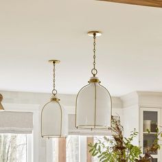 three lights hanging from the ceiling in a kitchen