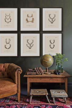 a living room filled with furniture and framed pictures on the wall above a coffee table