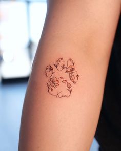 a person with a tattoo on their arm that has cats in the shape of a circle