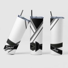 two white tumblers with black and grey designs on them, one has a straw in it