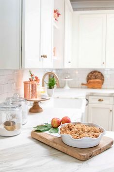 an apple crumbler sitting on top of a wooden cutting board in a kitchen