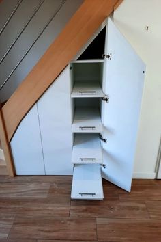 an open cabinet in the corner of a room