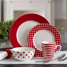 a red and white dinner set on a table