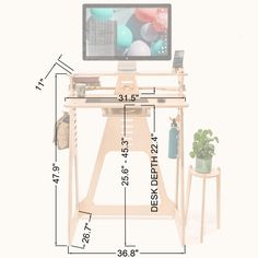 a computer monitor sitting on top of a wooden desk next to a potted plant