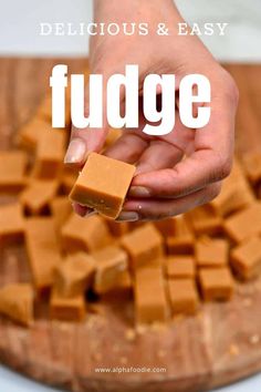 someone is holding a block of fudge on a cutting board with the words delicious and easy