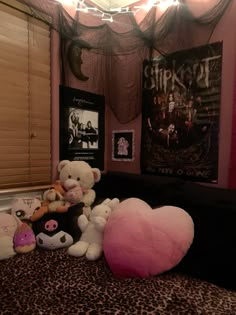 several stuffed animals sitting on top of a bed