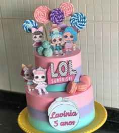 there is a multi layer cake decorated with lollipops