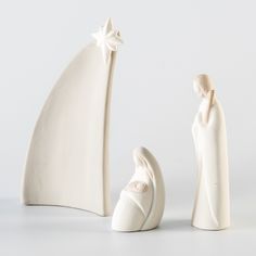 two white ceramic figurines are next to each other