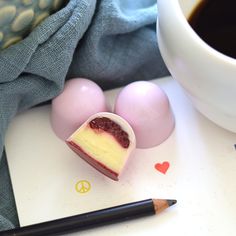 a piece of cake sitting on top of a table next to eggs and a cup of coffee