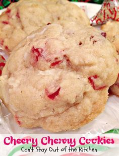 three cookies with cranberry toppings sitting on top of plastic wrapper next to each other