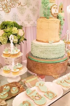 a table topped with lots of cakes and cupcakes