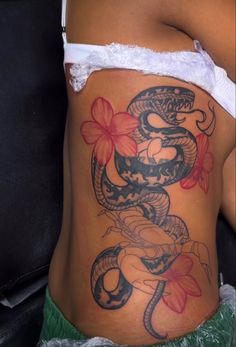 Black Women Stomach Tattoos, Calf Tattoos For Black Women, Women’s Side Stomach Tattoos, Side Of Stomach Tattoo For Black Women, Black Women Tramp Stamp, Women’s Side Stomach Tattoo, Cute Stomach Tattoos For Women, Tramp Stamp Tattoos Black Women, Black And White Snake