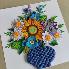 an art piece made out of legos and flowers on a white paper background,