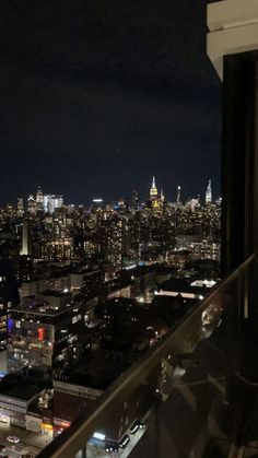 a view of the city at night from a high rise building in manhattan, new york