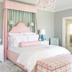 a pink and white bedroom with a canopy bed