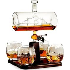 an old fashioned whiskey dispenser with six glasses on the tray and one empty glass in front