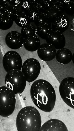 many black balloons with white numbers on them