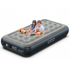 two children playing on an inflatable mattress