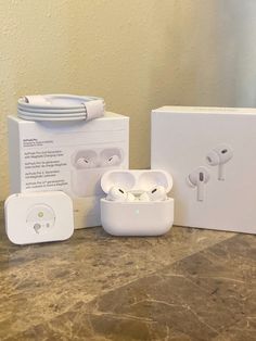 an image of apple airpods and packaging on the counter in front of a wall