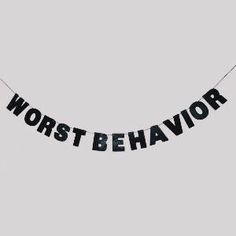 a banner that says worst behavior hanging from a string