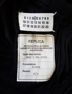 a label on the back of a black jacket that says replicaa reproduction of young garbers of varying sources