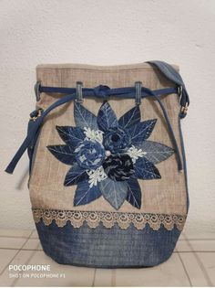 a purse with blue flowers and lace on it