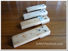 three pieces of wood sitting on top of a wooden floor with rivet holes in them