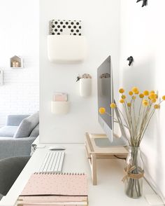 a white room with yellow flowers on the desk