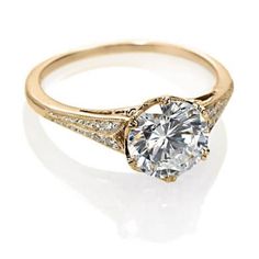 a gold ring with a diamond in the center and two rows of diamonds around it