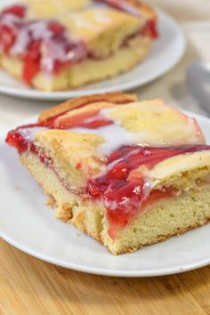 two slices of strawberry shortcake on white plates