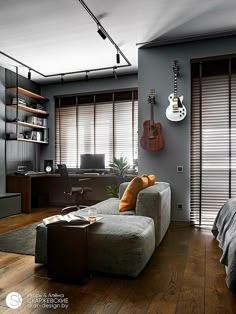 a living room filled with furniture and a guitar hanging on the wall next to it