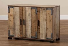 an old wooden cabinet with metal handles on the doors and wood planks around it