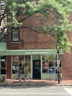 a bicycle is parked in front of a bank street coffee shop