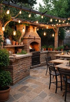 an outdoor kitchen with lights strung from the ceiling