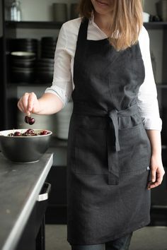 a woman in an apron is preparing food